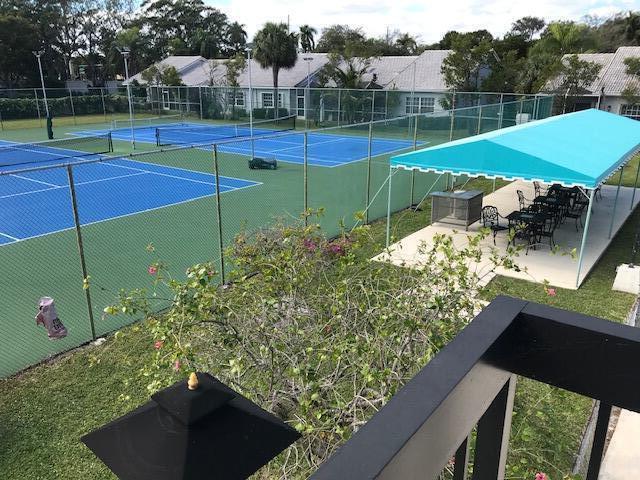 5280 Northwest 2nd Avenue, Unit 213 Boca Raton, FL 33487 - Photo 14 of 17 a view of a tennis ground with large trees