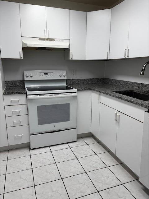 5280 Northwest 2nd Avenue, Unit 213 Boca Raton, FL 33487 - Photo 3 of 17 a kitchen with white cabinets and appliances