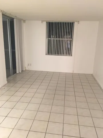 a view of a livingroom with an empty space and a window