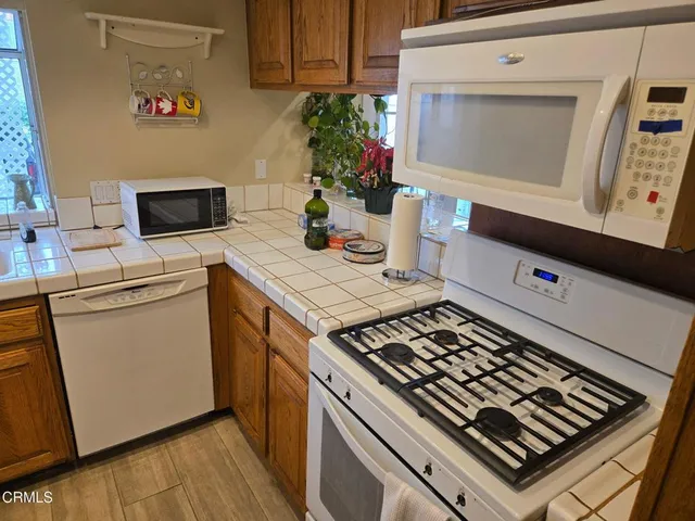 a stove top oven sitting inside of a kitchen