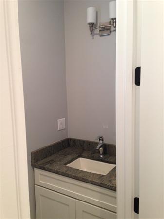 12 Willow Road Wellesley, MA 02482 - Photo 16 of 30 a bathroom with a granite countertop sink and white cabinets