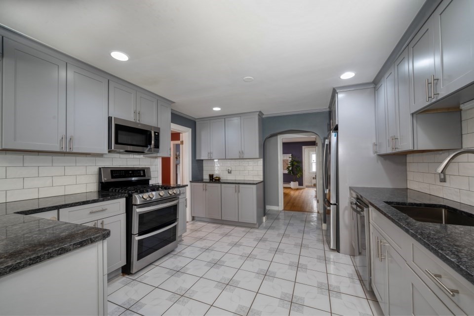 193 Vincent Road Dedham, MA 02026 - Photo 12 of 42 a kitchen with a sink a stove and cabinets