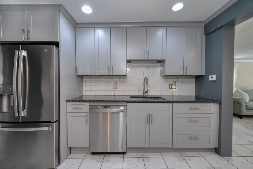 193 Vincent Road Dedham, MA 02026 - Photo 15 of 42 a kitchen with cabinets and stainless steel appliances