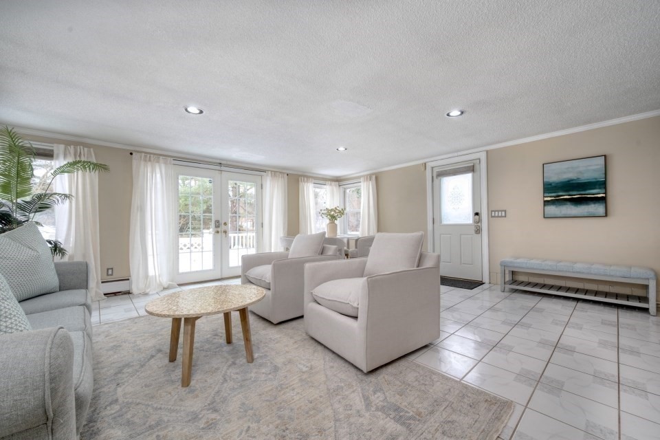 193 Vincent Road Dedham, MA 02026 - Photo 18 of 42 a living room with furniture a rug and a large window