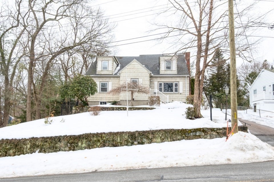 193 Vincent Road Dedham, MA 02026 - Photo 2 of 42 a view of a white house with a yard covered in snow