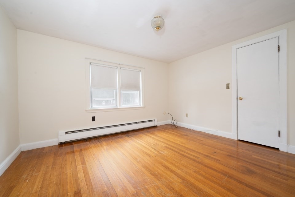 193 Vincent Road Dedham, MA 02026 - Photo 34 of 42 an empty room with wooden floor and windows