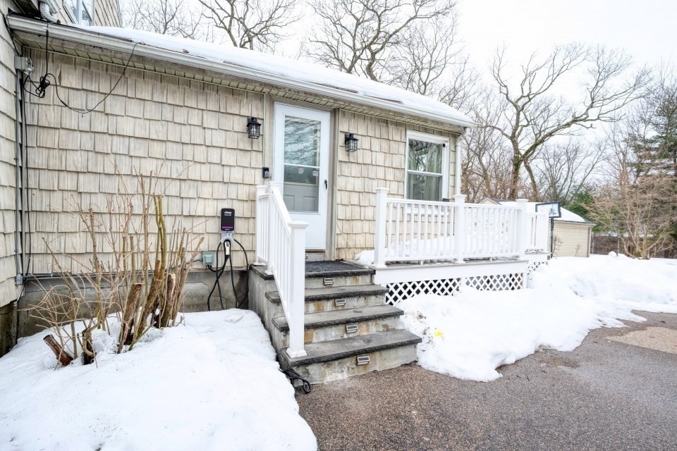 193 Vincent Road Dedham, MA 02026 - Photo 37 of 42 a front view of a house with a outdoor seating area