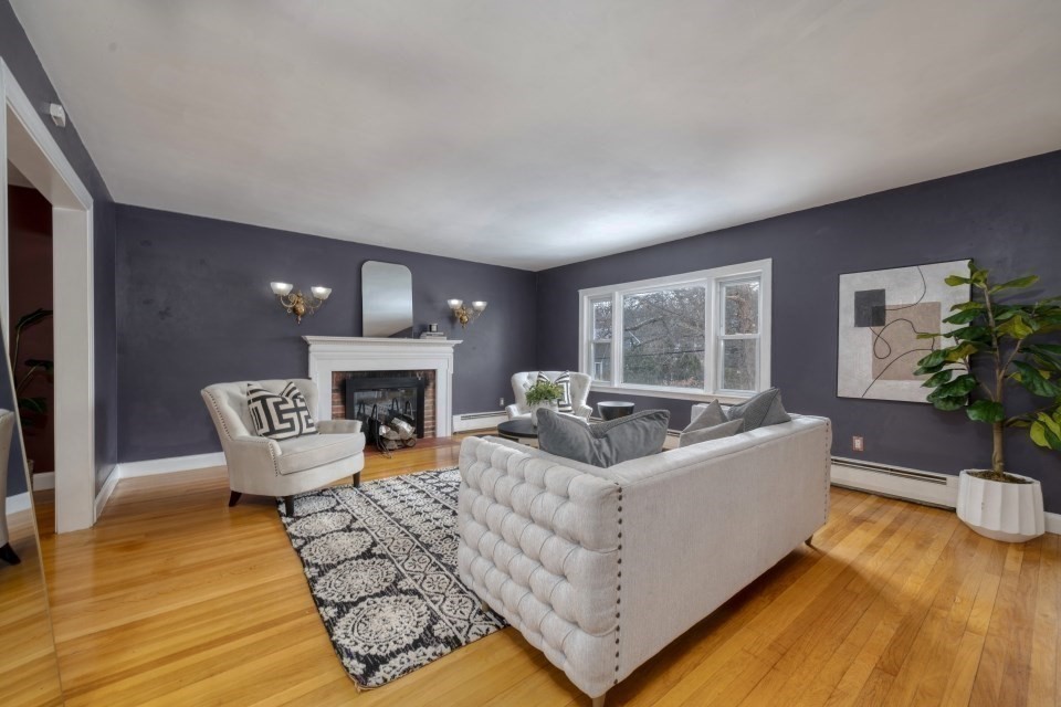 193 Vincent Road Dedham, MA 02026 - Photo 10 of 42 a living room with furniture a large window and a fireplace