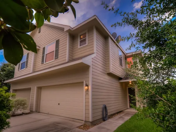 a view of a house with a yard and garage