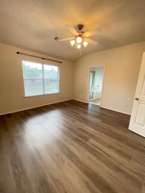 71 East Stedhill Loop Conroe, TX 77384 - Photo 7 of 10 a view of an empty room with wooden floor and a window