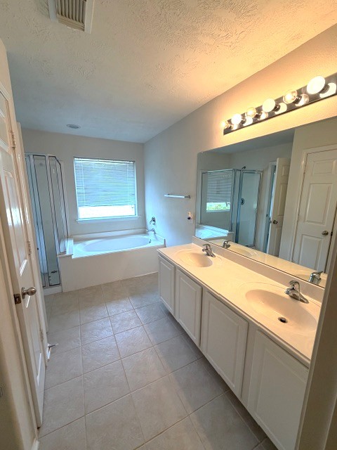 71 East Stedhill Loop Conroe, TX 77384 - Photo 9 of 10 a spacious bathroom with a tub a sink and a vanity