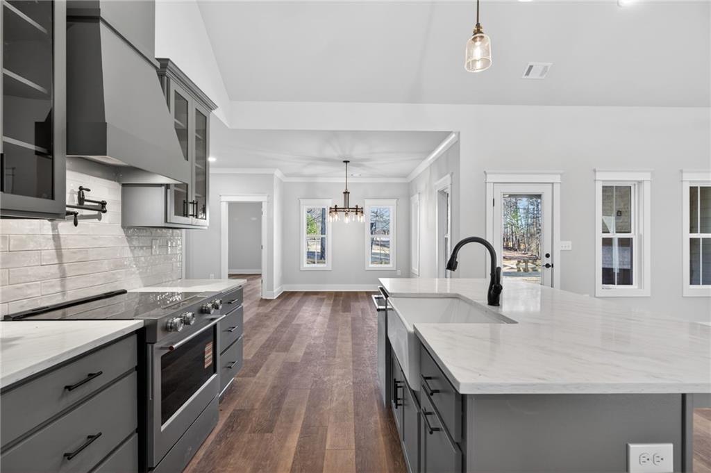 2203 Ridge Road Douglasville, GA 30134 - Photo 15 of 39 a kitchen with granite countertop a stove top oven a sink a counter space and cabinets