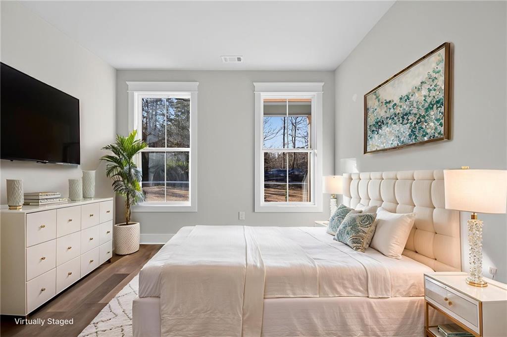 2203 Ridge Road Douglasville, GA 30134 - Photo 18 of 39 a bedroom with a large bed and a flat screen tv