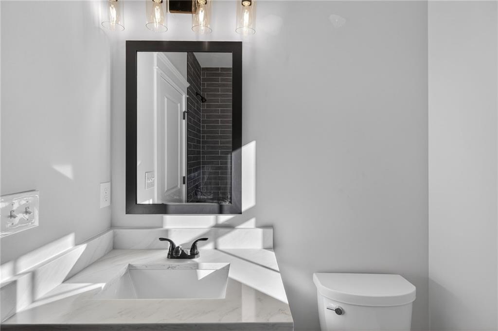 2203 Ridge Road Douglasville, GA 30134 - Photo 19 of 39 a bathroom with a sink a toilet and mirror
