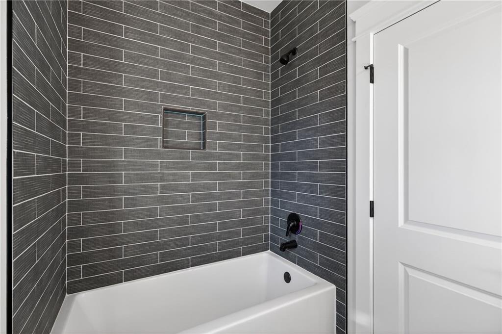 2203 Ridge Road Douglasville, GA 30134 - Photo 20 of 39 a bathroom with a bathtub and a shower