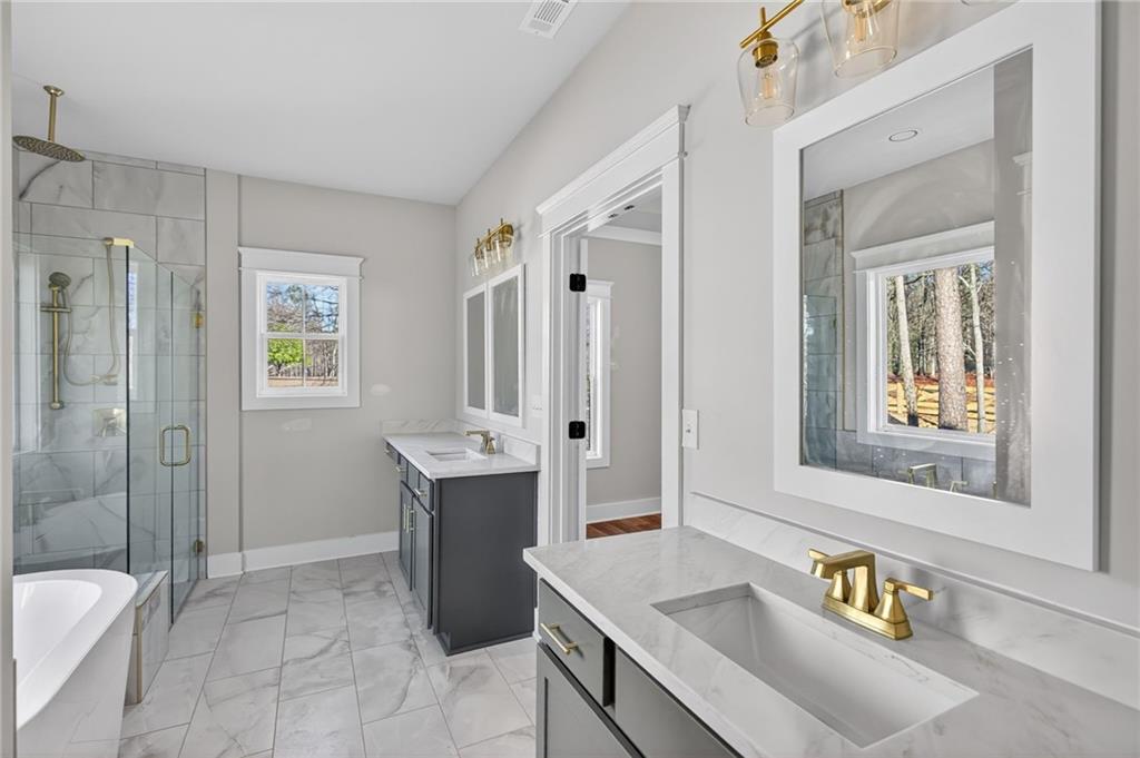 2203 Ridge Road Douglasville, GA 30134 - Photo 24 of 39 a bathroom with a tub sink and mirror