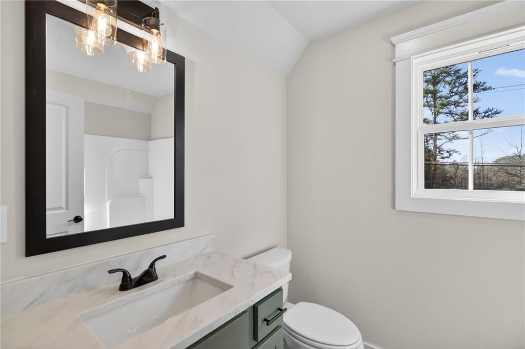 2203 Ridge Road Douglasville, GA 30134 - Photo 31 of 39 a bathroom with a sink vanity mirror and toilet