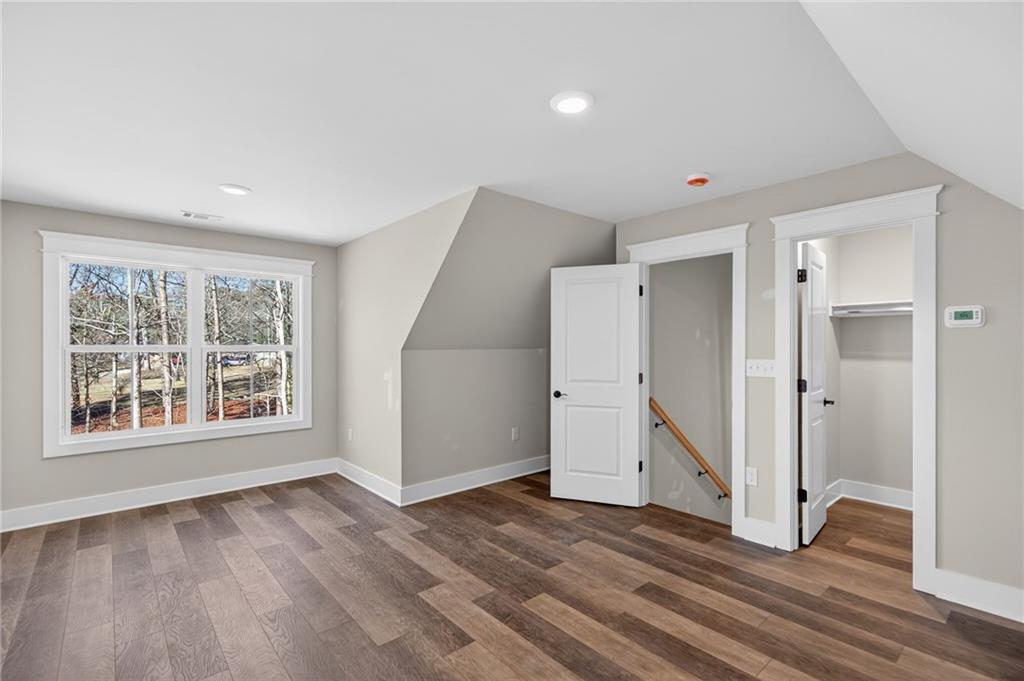 2203 Ridge Road Douglasville, GA 30134 - Photo 32 of 39 an empty room with wooden floor cabinet and windows