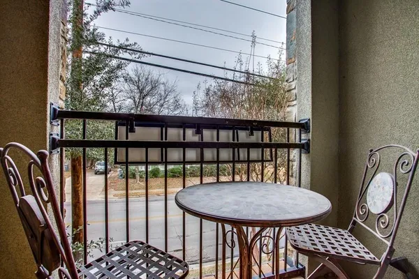 a view of a balcony dining area with furniture