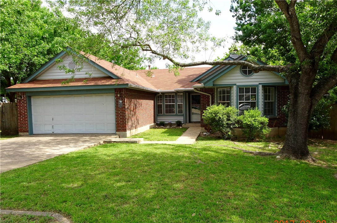 2201 Raintree Path Round Rock, TX 78664 - Photo 1 of 1 a front view of a house with a garden and trees