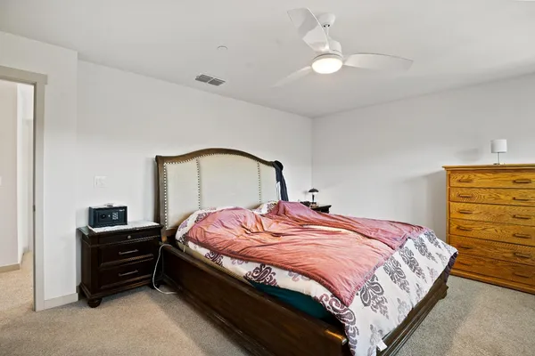 a bedroom with a bed and dresser