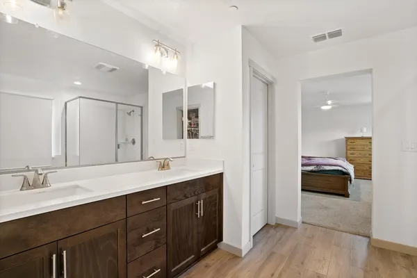 a en suite bathroom with a double sink double vanity and mirror