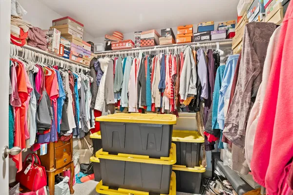 a view of walk in closet with clothes