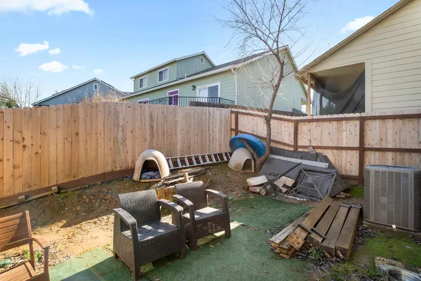a backyard of a house with table and chairs