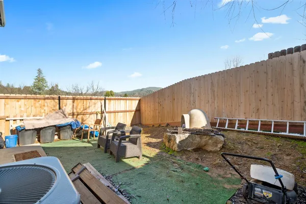 a view of a house with backyard porch and furniture