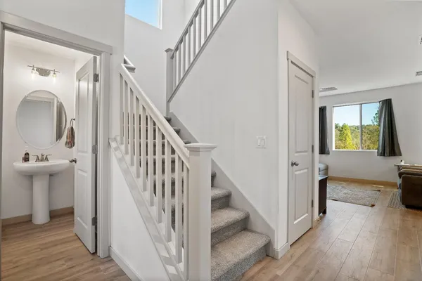 a view of a hallway view with wooden floor and staircase
