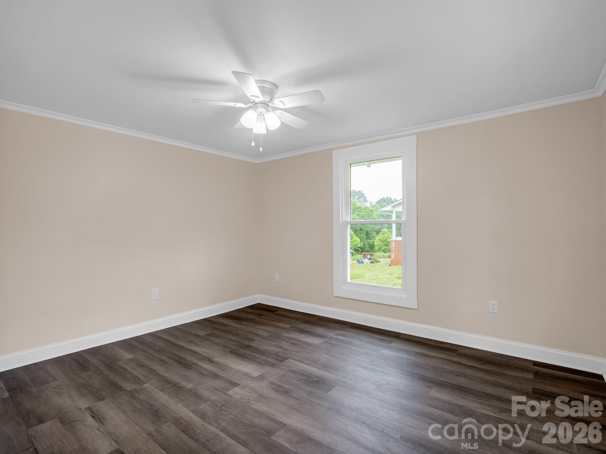 170 Dobbins Road Ellenboro, NC 28040 - Photo 17 of 32 an empty room with wooden floor window and ceiling fan