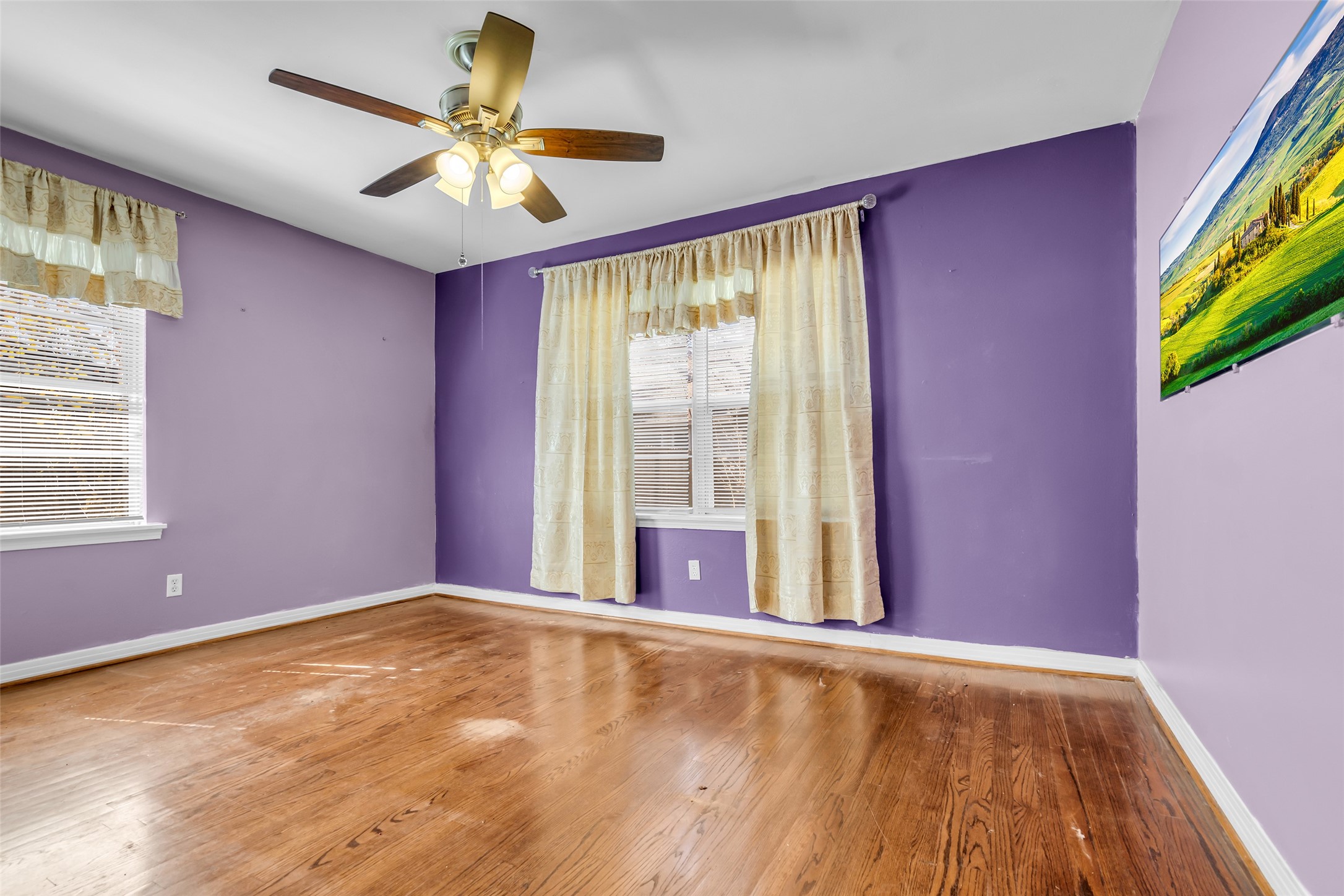 4825 Ella Boulevard Houston, TX 77018 - Photo 17 of 27 a view of an empty room with a window and a flat screen tv