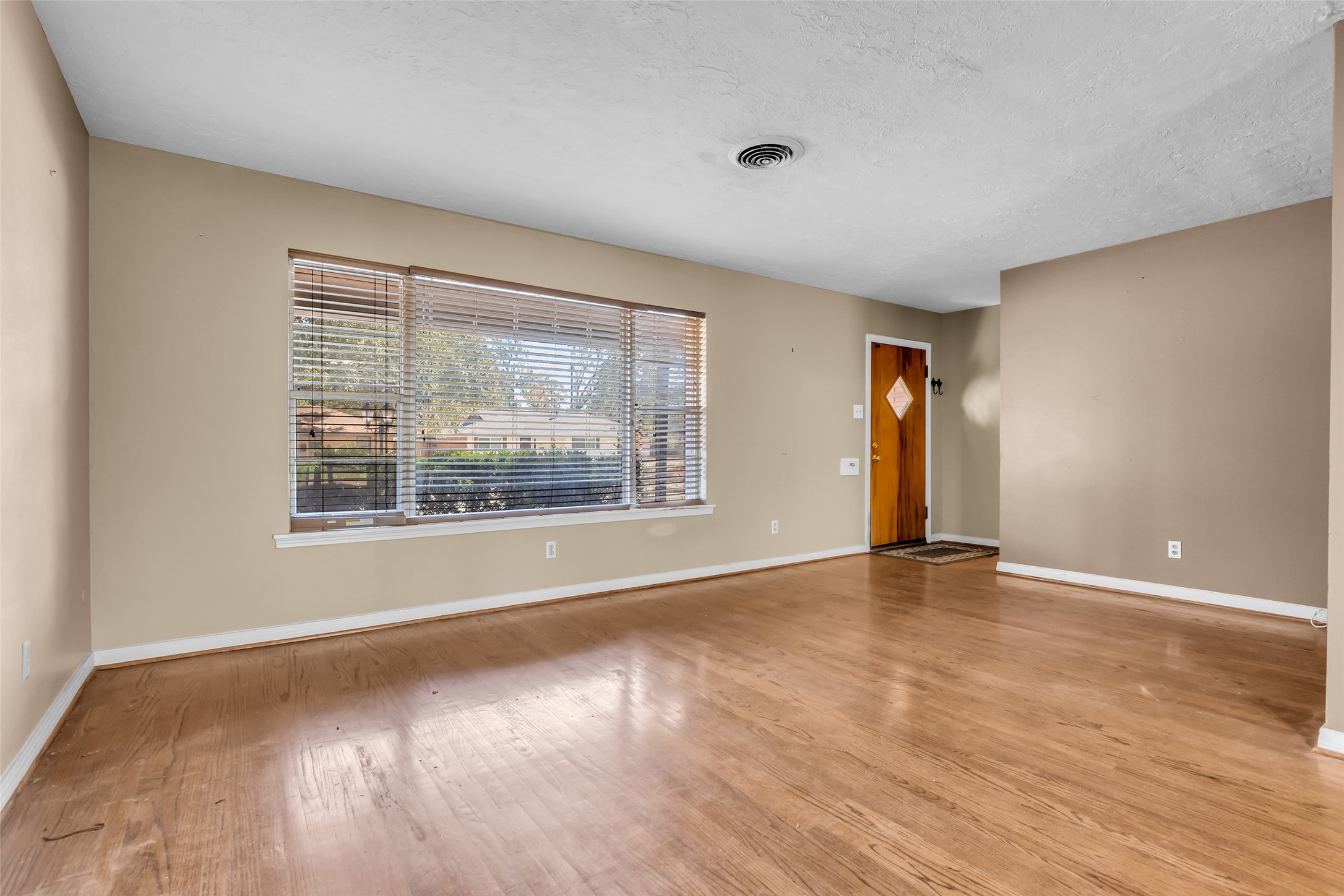 4825 Ella Boulevard Houston, TX 77018 - Photo 7 of 27 a view of an empty room with glass door and wooden floor