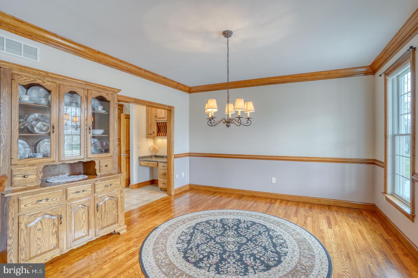 520 Mud Mill Road Marydel, DE 19964 - Photo 17 of 123 a view of an empty room and kitchen with window wooden floor and a chandelier
