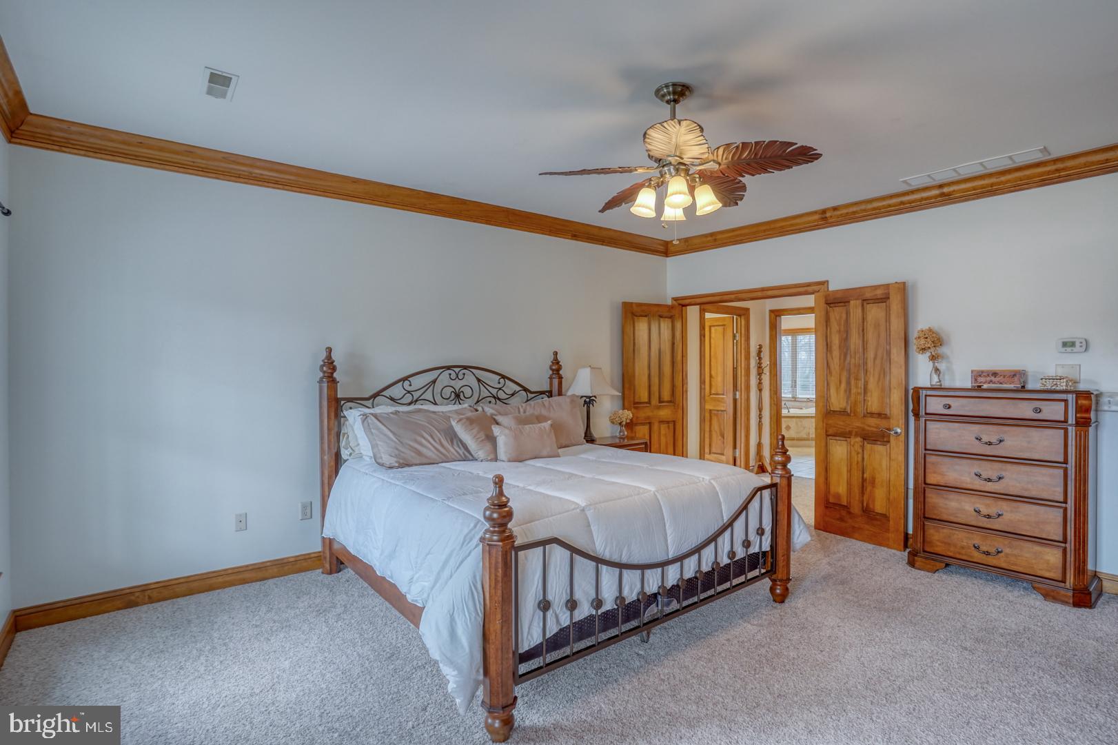 520 Mud Mill Road Marydel, DE 19964 - Photo 40 of 123 a bedroom with a bed and a chandelier