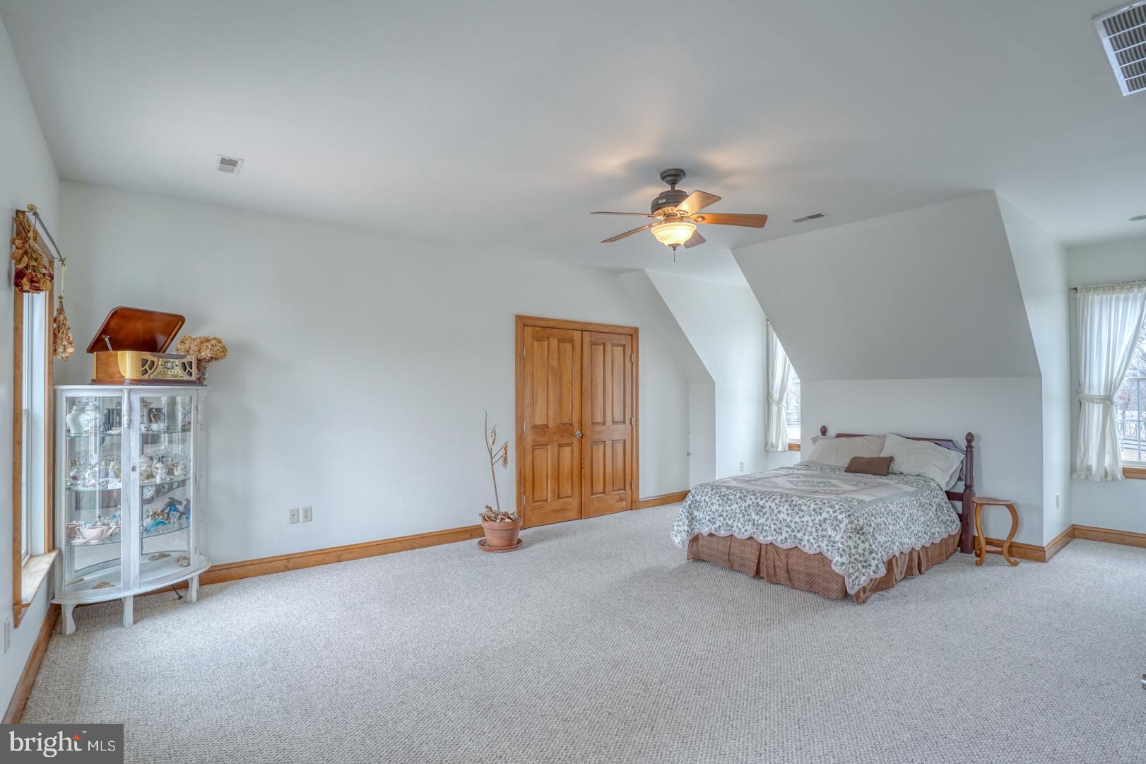 520 Mud Mill Road Marydel, DE 19964 - Photo 45 of 123 a spacious bedroom with a bed and a chandelier
