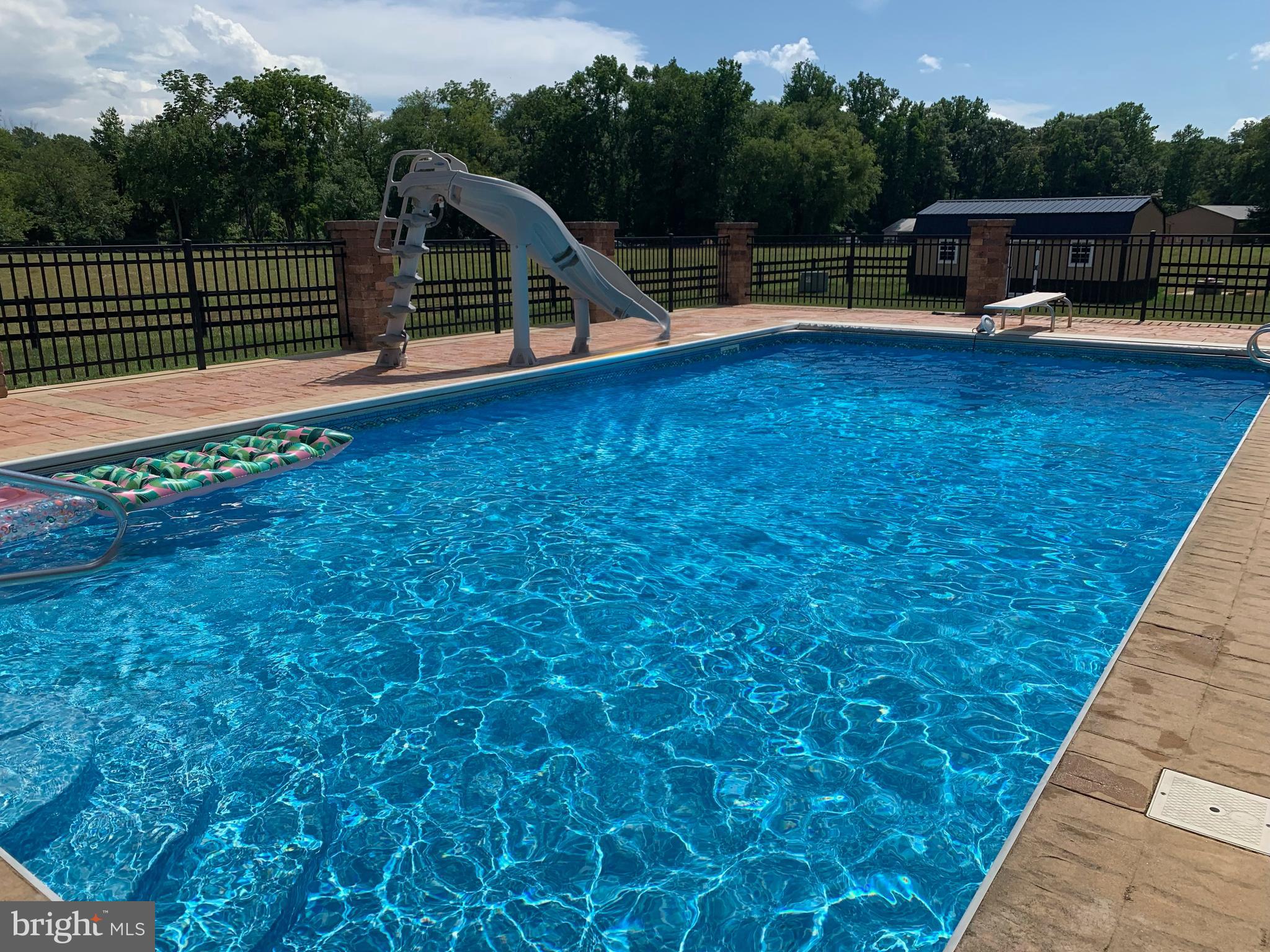 520 Mud Mill Road Marydel, DE 19964 - Photo 9 of 123 a view of a roof deck with table and chairs a barbeque with wooden floor and fence