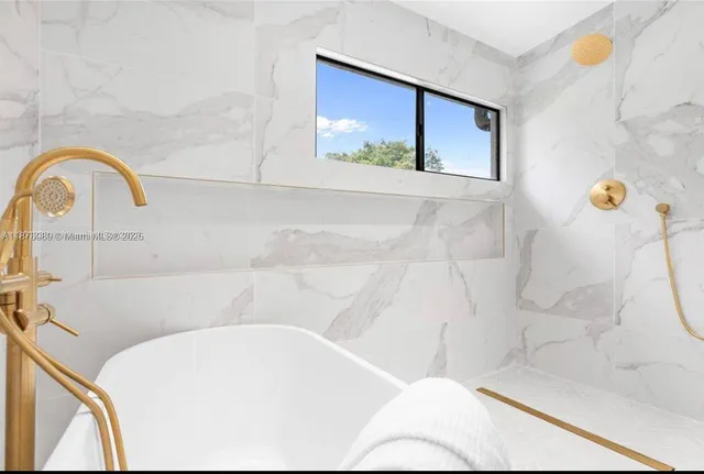 a white bath tub sitting in a bathroom