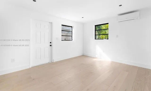 a bedroom with a bed and painting on the wall