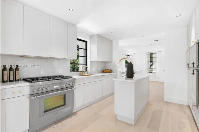 a kitchen with white cabinets and white appliances