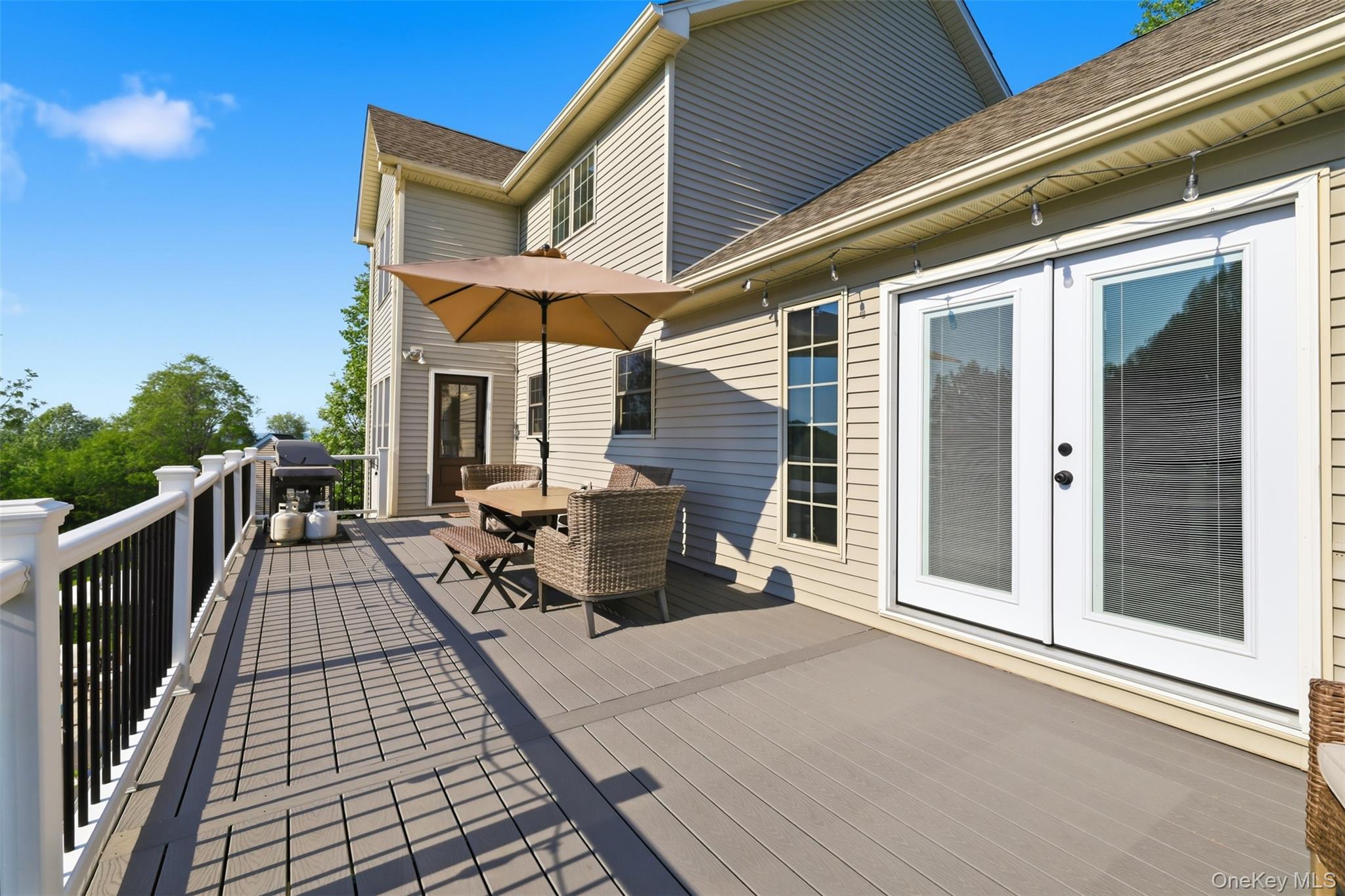 233 Devon Farms Road Stormville, NY 12582 - Photo 37 of 48 a view of a patio with couches chairs and wooden floor
