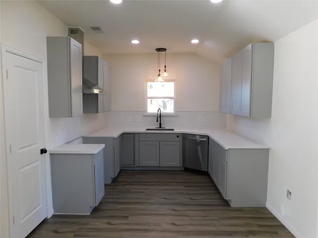 a kitchen with a sink cabinets and window