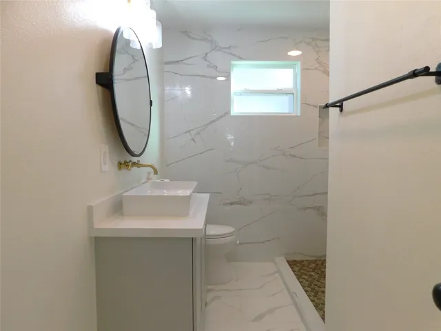 a bathroom with a sink a mirror and a shower