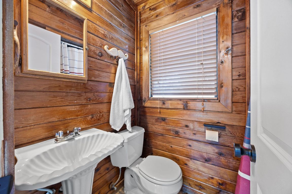 1815 Eckhardt Street Taylor, TX 76574 - Photo 15 of 33 a bathroom with a toilet a sink and a window