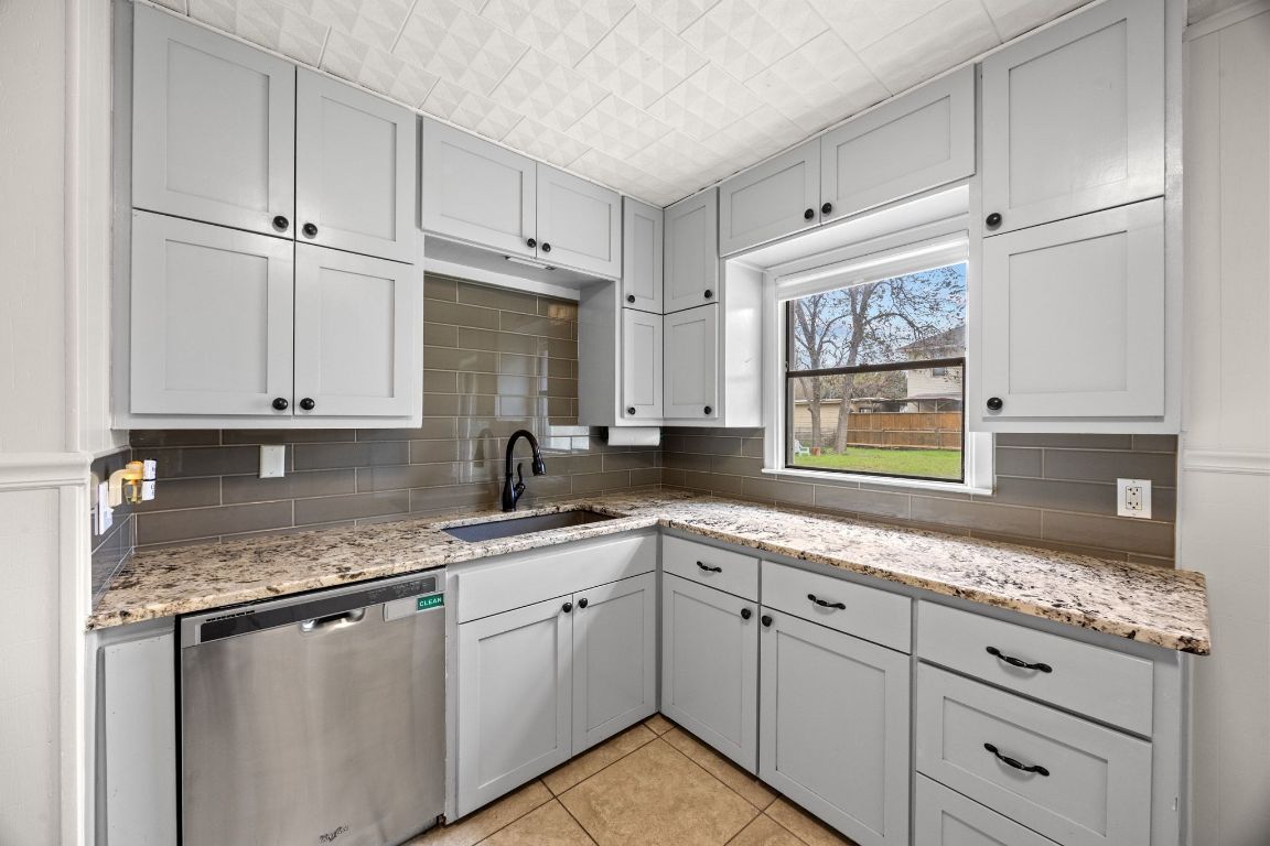 1815 Eckhardt Street Taylor, TX 76574 - Photo 18 of 33 a kitchen with appliances cabinets and a sink