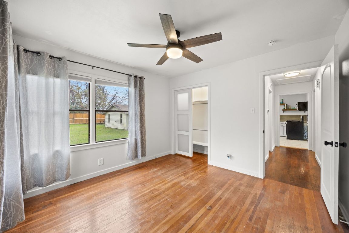 1815 Eckhardt Street Taylor, TX 76574 - Photo 26 of 33 a view of an empty room with wooden floor and a window
