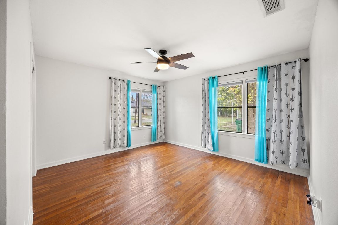 1815 Eckhardt Street Taylor, TX 76574 - Photo 27 of 33 a view of an empty room with a window and wooden floor