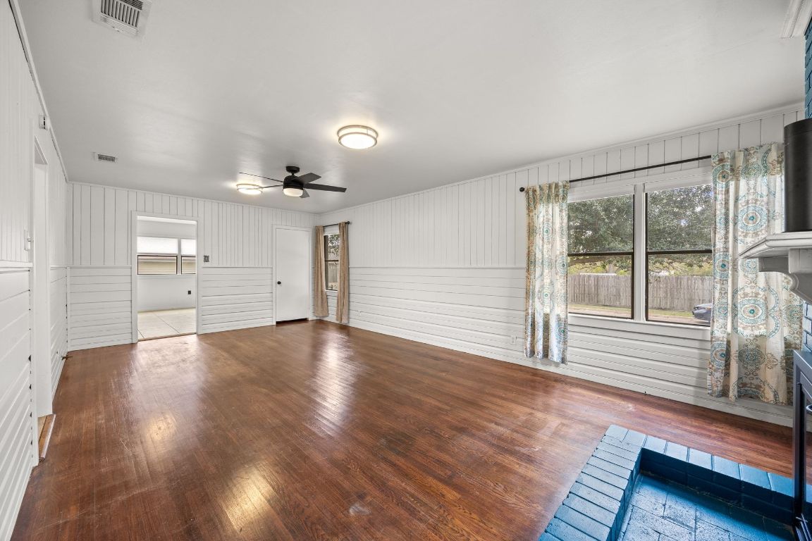 1815 Eckhardt Street Taylor, TX 76574 - Photo 8 of 33 wooden floor in an empty room with a window