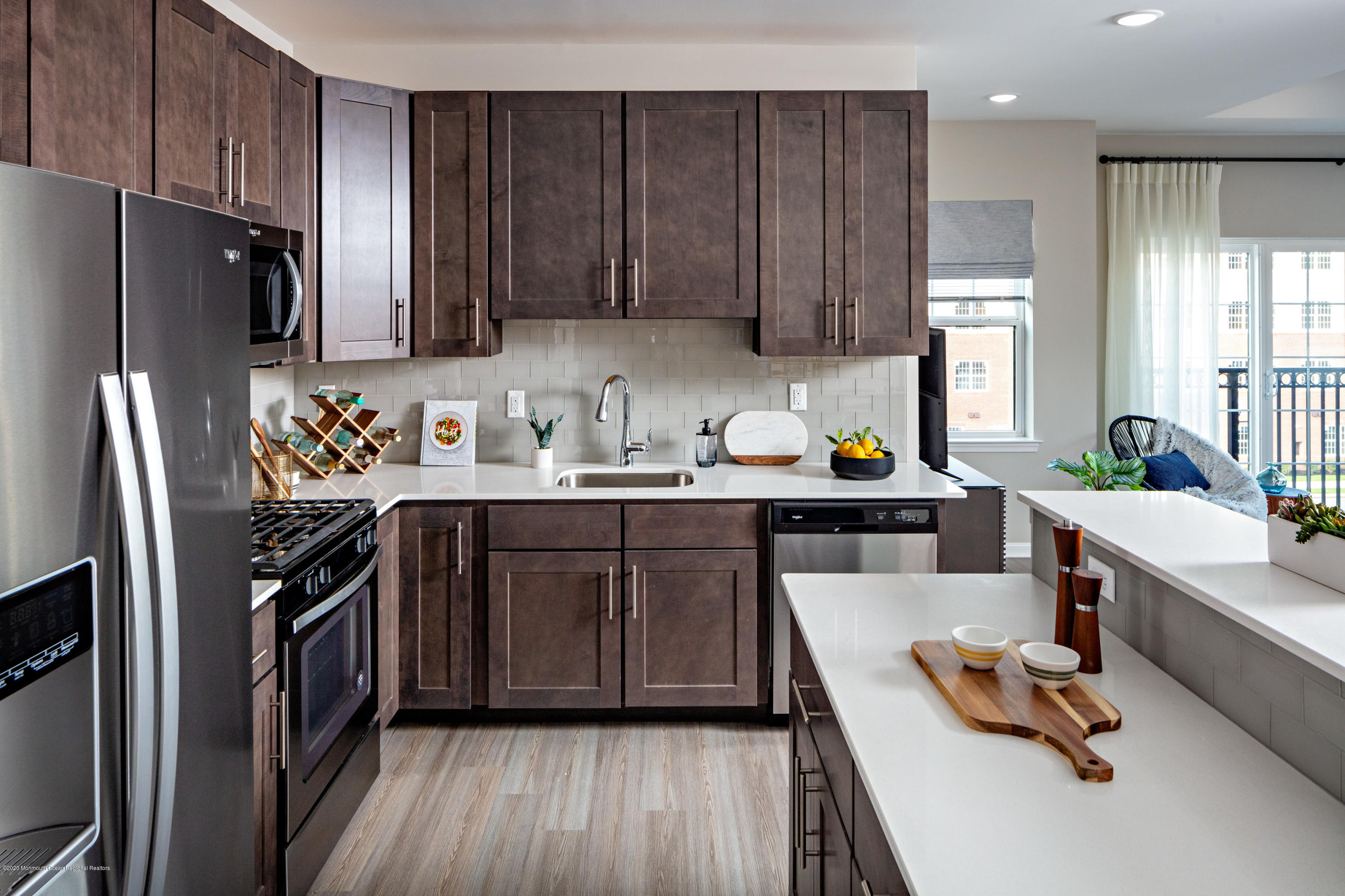 627 Jessica Circle Freehold, NJ 07728 - Photo 11 of 15 a kitchen with a refrigerator a sink dishwasher stove and oven with wooden floor