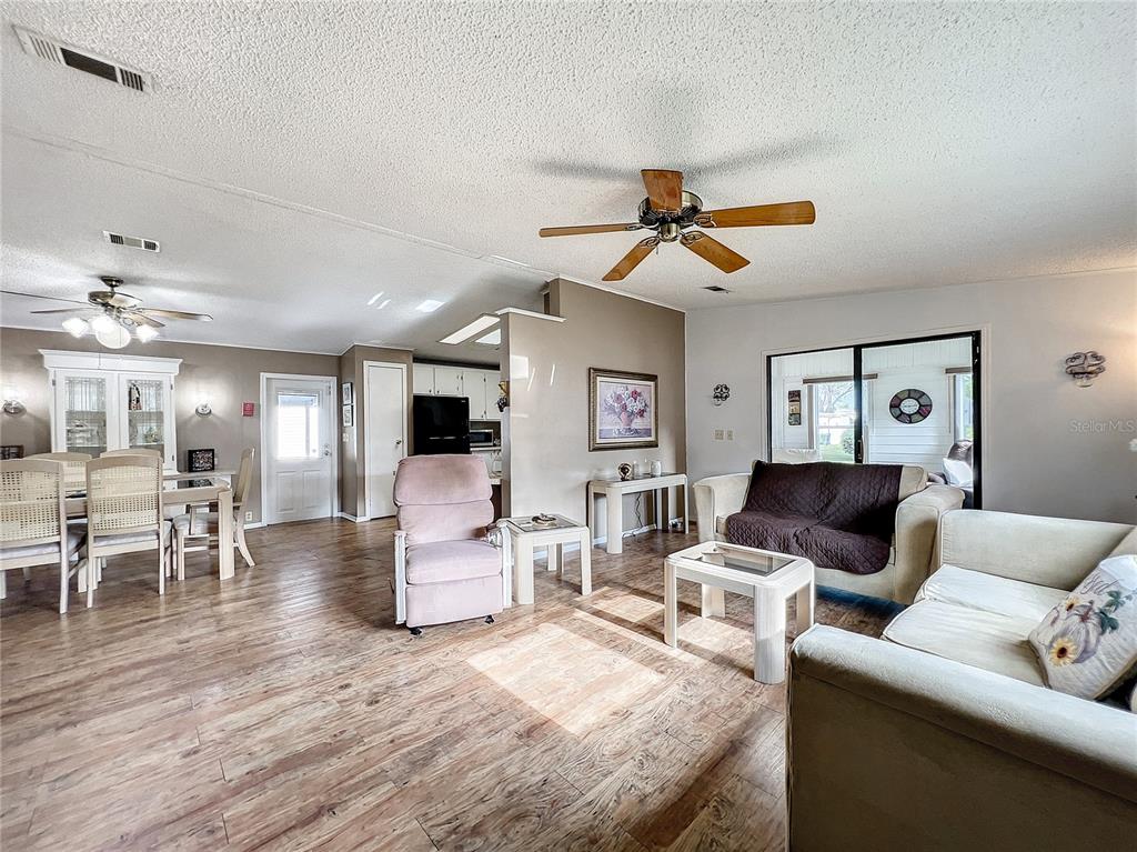 6518 Raintree Lane Winter Haven, FL 33881 - Photo 11 of 42 a living room with furniture and a wooden floor